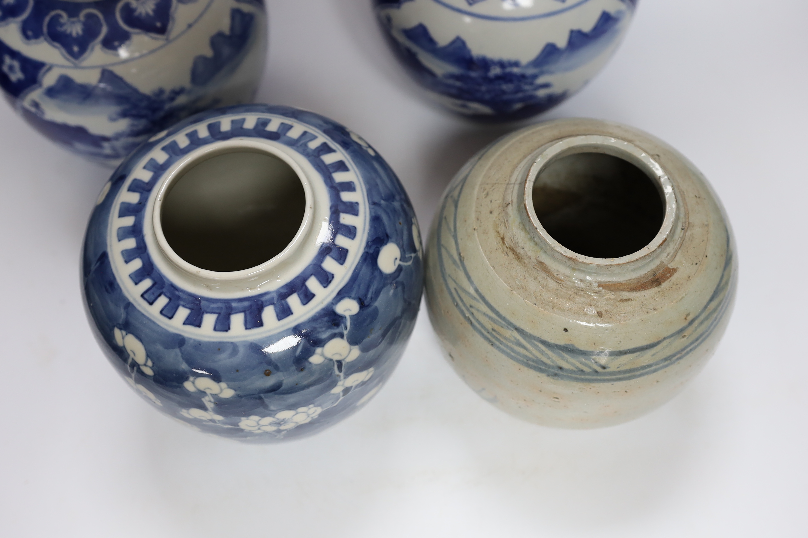 Four Chinese ginger jars, including a blue and white pair with covers and a prunus flower example, largest 21cm high